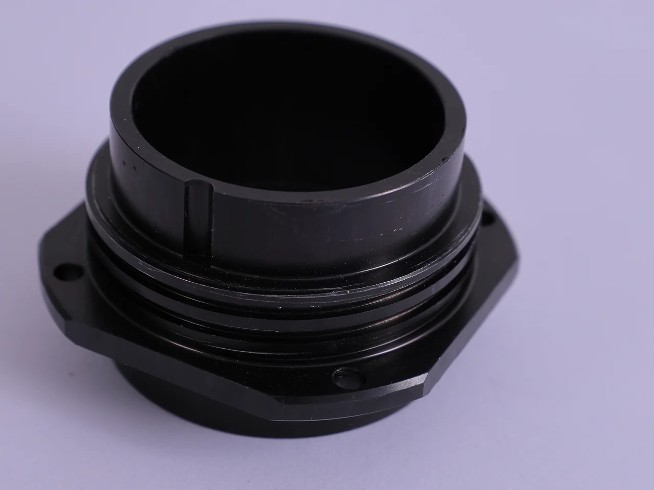 Black-anodised machined flanged housing with a threaded neck, keyed bore and two mounting lugs